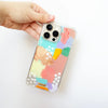 Funda para proteger iPhone, pintada a mano por Ana Tere Canales. Un diseño en tonos pasteles con toques rose gold.