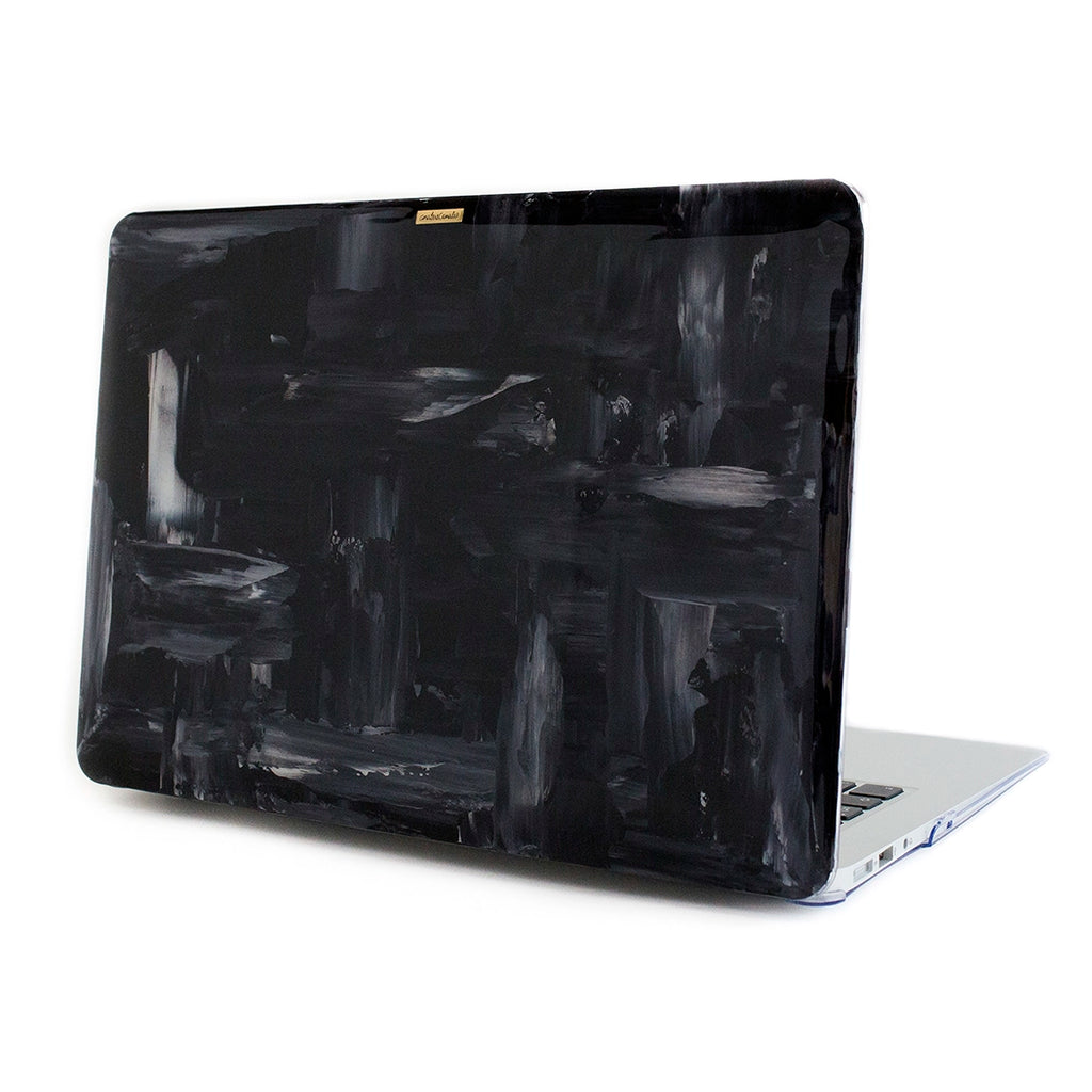 Funda para MacBook Blackout Illusion pintada a mano por Ana Tere Canales. Diseño abstracto en blanco y negro inspirado en ilusiones ópticas.