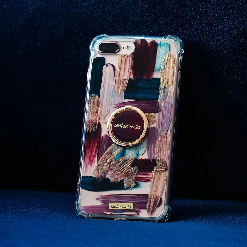 Funda para proteger iPhone con holder, pintados a mano por Ana Tere Canales. Un diseño con tonalidades rosas, azules, vino y rose gold.