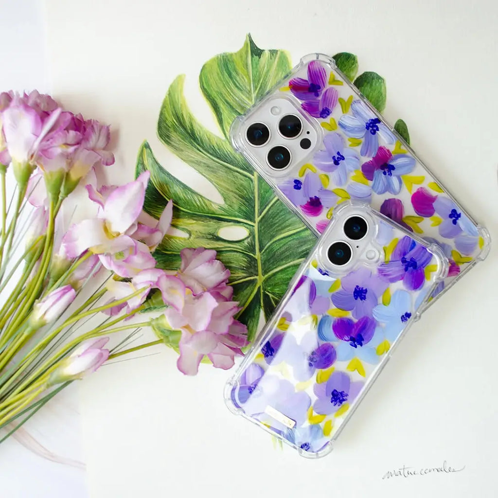 Funda para proteger iPhone, pintada a mano por Ana Tere Canales. Un diseño de flores en morados y verdes.
