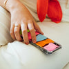 Funda para iPhone Summer Sunset pintada a mano por Ana Tere Canales. Un diseño artístico inspirado en un atardecer de verano en tonos cálidos y vibrantes.